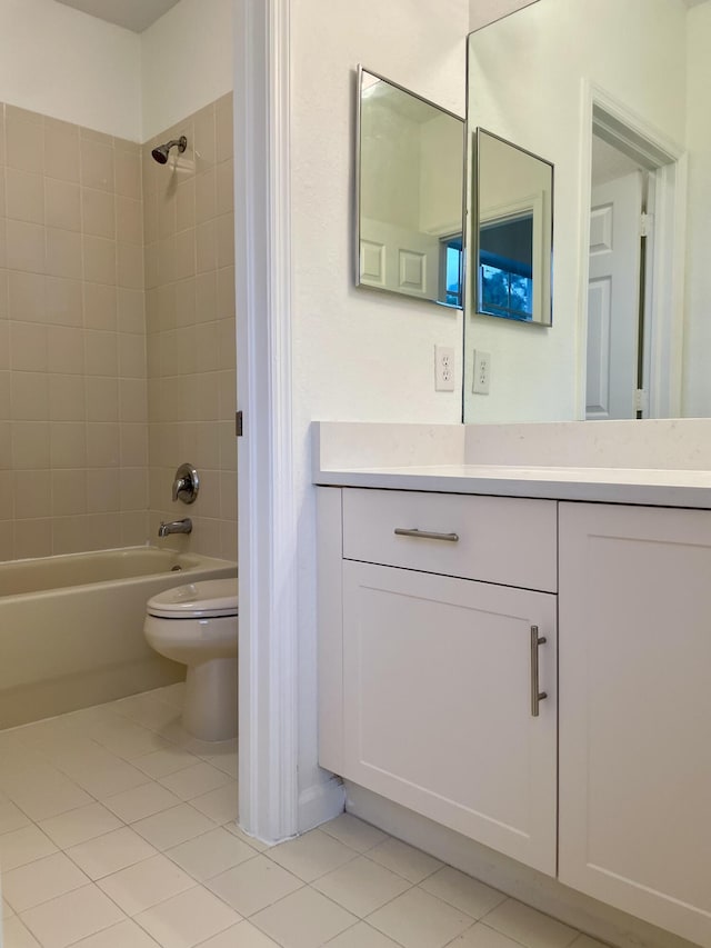 full bathroom featuring toilet, tiled shower / bath combo, tile patterned flooring, and vanity