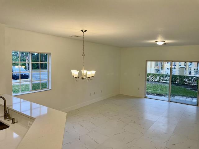 empty room featuring a chandelier