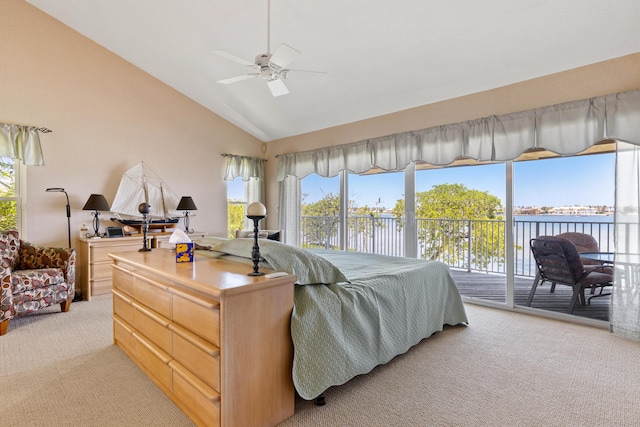 carpeted bedroom with access to outside, high vaulted ceiling, and a water view