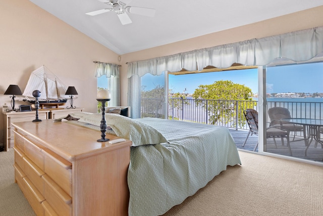 carpeted bedroom featuring multiple windows, a water view, access to outside, and lofted ceiling