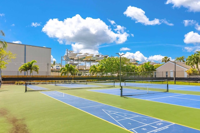 view of tennis court featuring basketball hoop