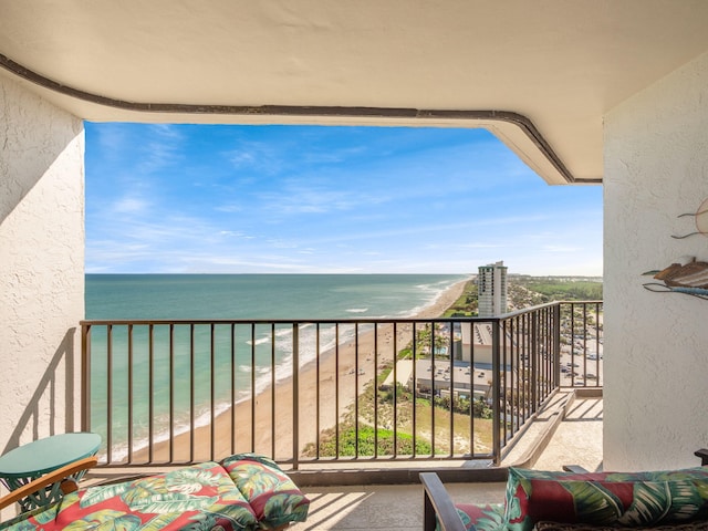 balcony with a view of the beach and a water view