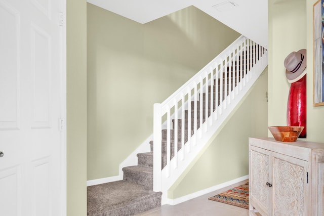 stairway with tile patterned flooring