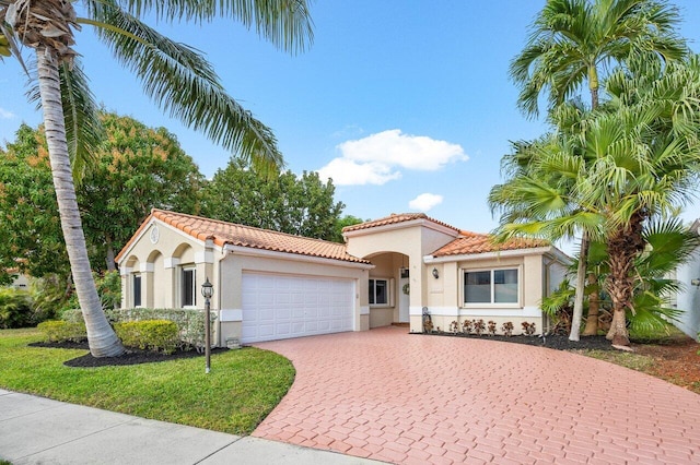 mediterranean / spanish-style house with a garage