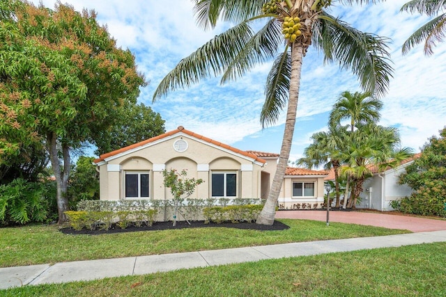 mediterranean / spanish-style house featuring a front yard