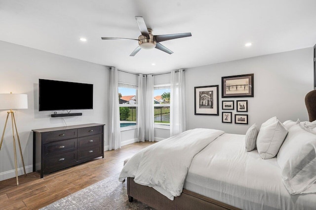 bedroom with ceiling fan and light wood-type flooring