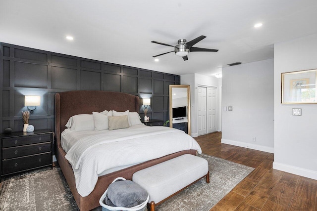 bedroom with dark wood-type flooring, ceiling fan, and a closet