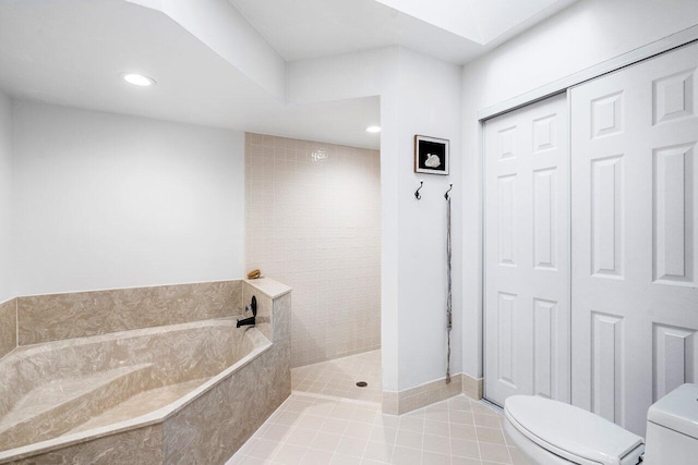 bathroom with toilet, plus walk in shower, and tile patterned floors