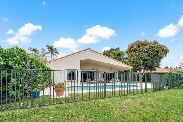 view of swimming pool featuring a patio area, ceiling fan, and a yard