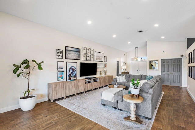 living room featuring lofted ceiling and a textured ceiling