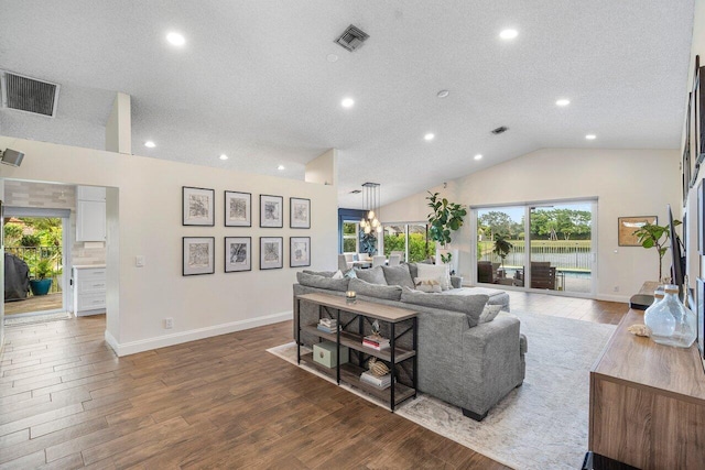 living room featuring lofted ceiling and a textured ceiling