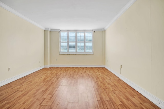 unfurnished room with ornamental molding and light hardwood / wood-style floors