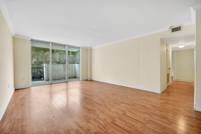 unfurnished room featuring ornamental molding, a wall of windows, and light hardwood / wood-style flooring