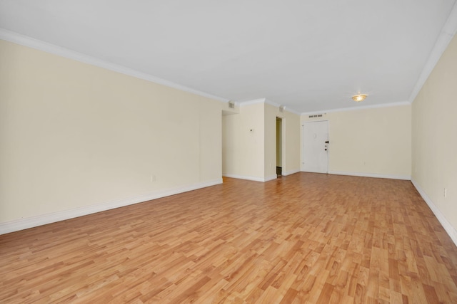 unfurnished room with ornamental molding and light hardwood / wood-style floors