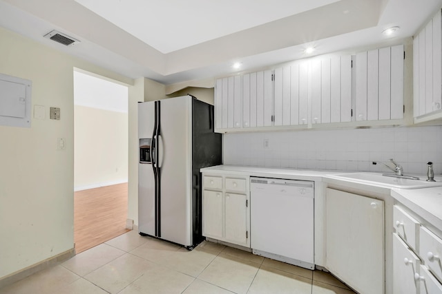 kitchen with dishwasher, light tile patterned floors, white cabinetry, fridge with ice dispenser, and sink