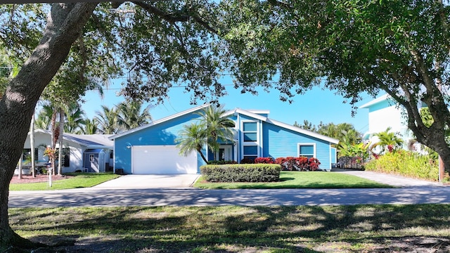 ranch-style home featuring a front yard and a garage