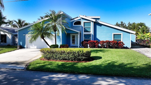 view of front of property featuring a garage and a front lawn