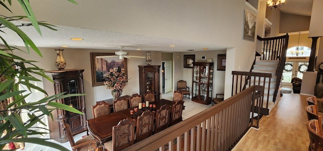 hall with a high ceiling, stairs, wood finished floors, and a chandelier