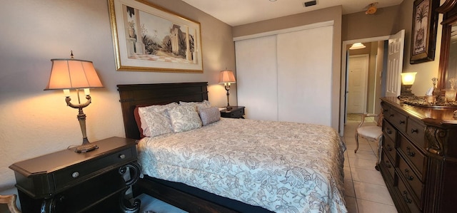 bedroom featuring light tile patterned floors, a closet, and visible vents