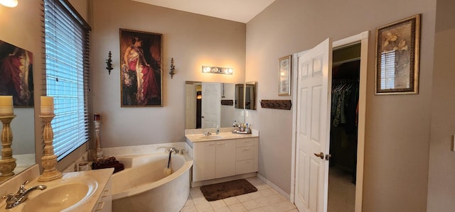 full bath with a bath, two vanities, a sink, and tile patterned floors