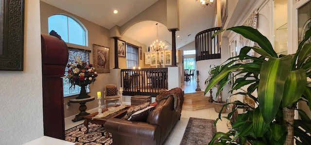 living area with arched walkways, a wealth of natural light, decorative columns, and a chandelier