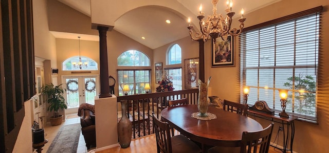 dining area with recessed lighting, a notable chandelier, high vaulted ceiling, wood finished floors, and french doors