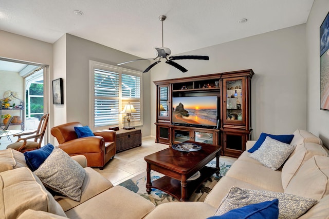 living room with light tile patterned floors, a wealth of natural light, and ceiling fan