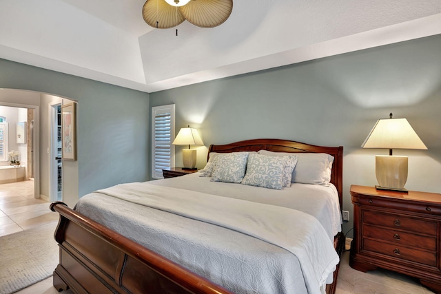 tiled bedroom with ceiling fan and ensuite bathroom