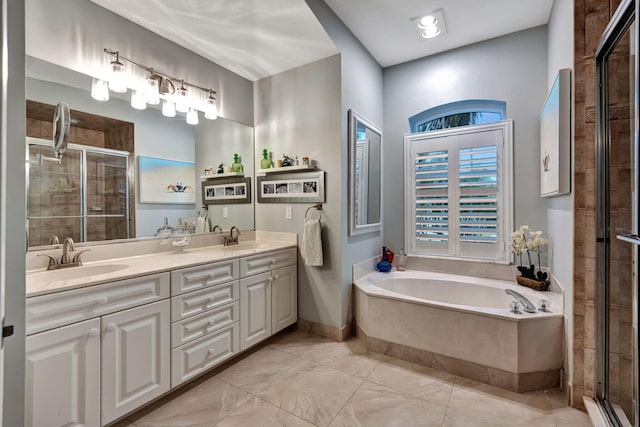 bathroom with vanity and shower with separate bathtub