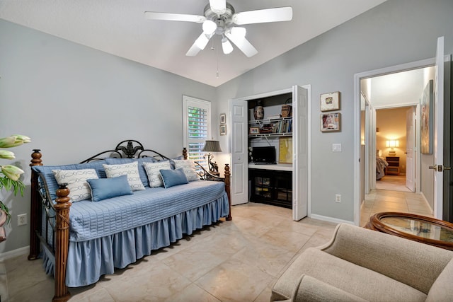 bedroom with ceiling fan, vaulted ceiling, and a closet