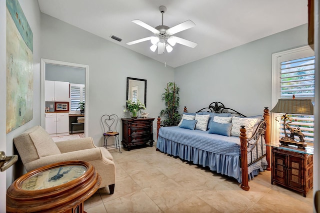 bedroom featuring vaulted ceiling, light tile patterned flooring, and ceiling fan