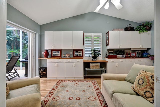 kitchen with white cabinetry, backsplash, vaulted ceiling, and light hardwood / wood-style floors