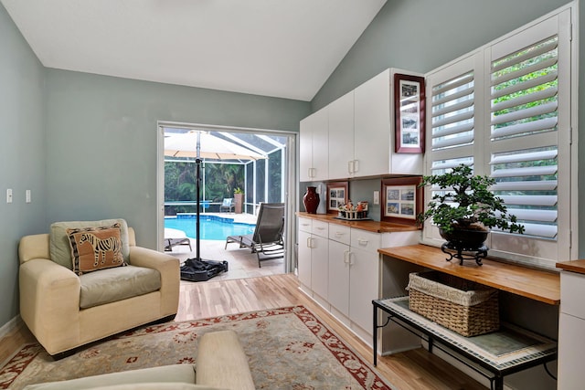 interior space featuring light hardwood / wood-style flooring, a healthy amount of sunlight, and vaulted ceiling