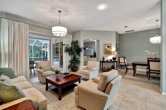 living room with a notable chandelier and light tile patterned floors