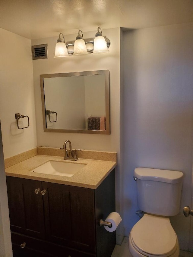 bathroom featuring toilet and vanity