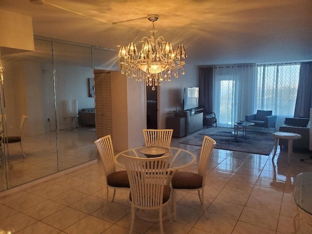 dining space with an inviting chandelier and light tile patterned flooring