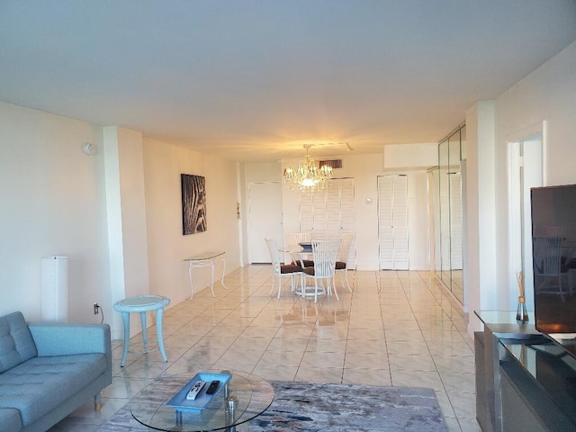 living room with light tile patterned flooring and an inviting chandelier