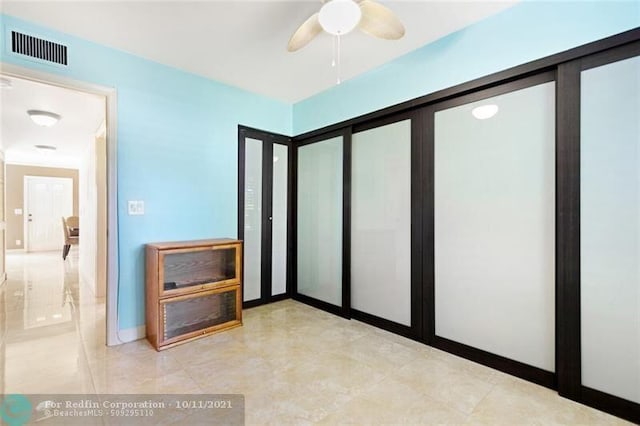 unfurnished bedroom featuring visible vents, ceiling fan, and baseboards