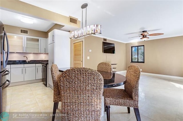 dining area featuring light tile patterned floors, ceiling fan, visible vents, and baseboards