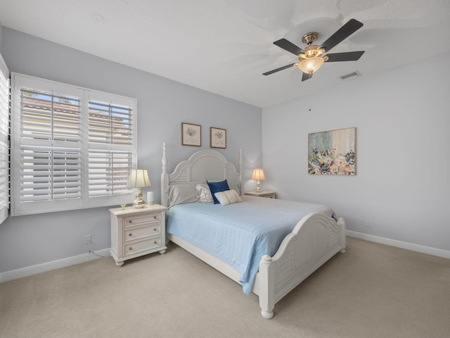 bedroom featuring ceiling fan and light carpet