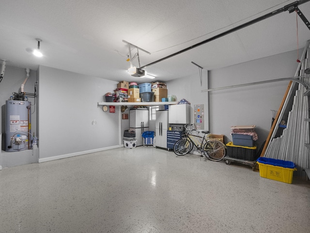 garage with refrigerator, a garage door opener, gas water heater, and white fridge