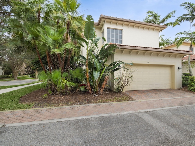 mediterranean / spanish home with a garage