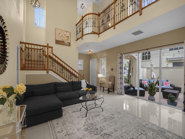 living room with tile patterned floors and a high ceiling