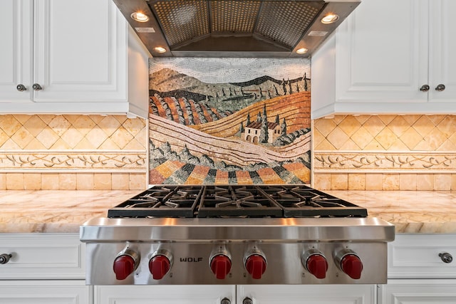 kitchen with custom exhaust hood, stainless steel gas stovetop, tasteful backsplash, and white cabinetry