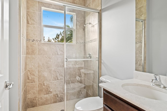 bathroom with vanity, walk in shower, and toilet