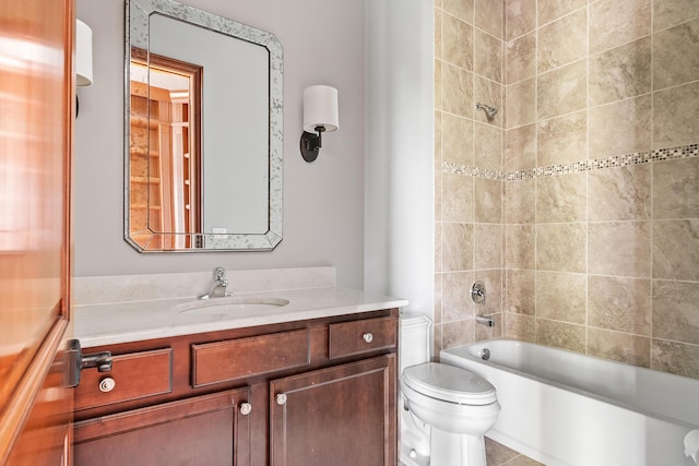 full bathroom featuring toilet, vanity, and tiled shower / bath combo