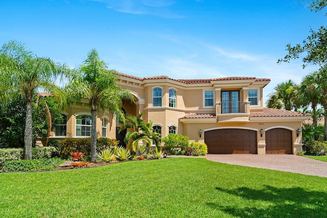 mediterranean / spanish-style home featuring a front lawn and a garage