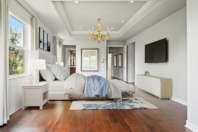 unfurnished bedroom featuring hardwood / wood-style flooring, a raised ceiling, ornamental molding, and a chandelier