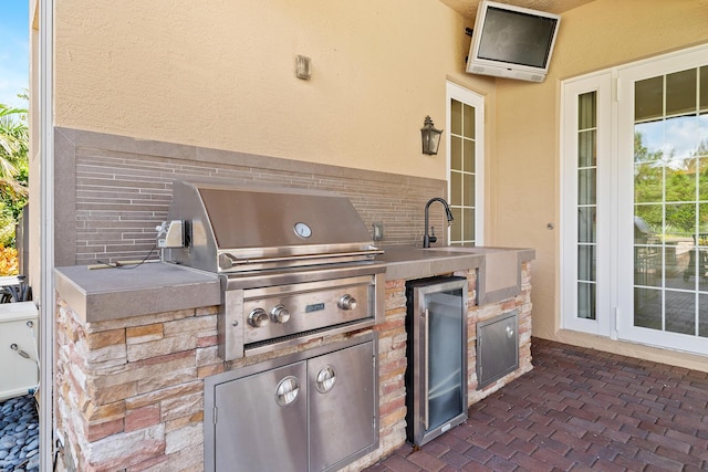 view of patio featuring exterior kitchen and grilling area