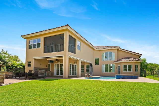 rear view of house with a yard, ceiling fan, and a patio area